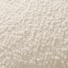 Ivory boucle fabric texture on a square decorative pillow