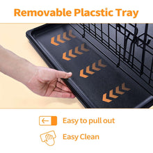 Removable black plastic tray for dog crate, being pulled out by hand