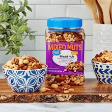 Mixed nuts jar with blue cap and purple label, with nuts shown in surrounding bowls