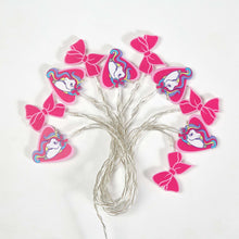 Unicorn string lights with pink bow cutouts and silver wire