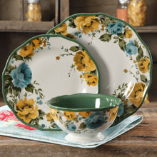 Floral dinner plate with green rim and blue-yellow rose design