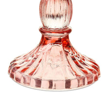 Pink glass taper candle holder with fluted round base and decorative ridges