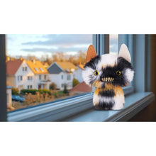 Calico cat ugly monster stuffed toy with black, white, and orange fur and yellow eyes