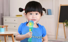 Child holding a teal sing-along microphone with a yellow sun light panel