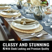Stainless steel tableware set with spoons and forks on a decorated dining table