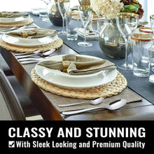 Dining table setting with stainless cutlery, plates, and folded napkins
