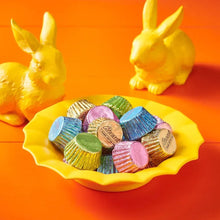 Mini peanut butter cups in colorful wrappers with bunny figurines