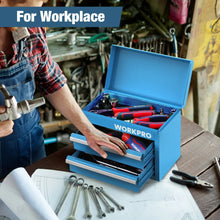 Blue mini metal tool box open on a workbench with tools in drawers