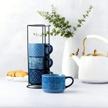 Blue patterned stacking mugs on wire rack with one mug in front