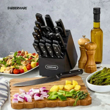 Black cutlery block set with stainless knives and kitchen shears on countertop