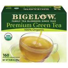 Bigelow Premium Green Tea carton with brewed tea in glass cup