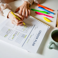 Yellow chisel-tip highlighter pen marking a printed worksheet