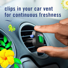 Febreze Car vent clip air freshener with green reservoir being attached to a car vent