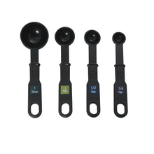 Black measuring spoons with 1 tbsp and 1/2 tsp and 1/4 tsp markings