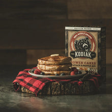 Kodiak power cakes buttermilk mix box with stack of pancakes and berries