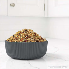 Black ribbed plastic cereal bowl filled with dry cereal