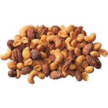 Heap of honey roasted mixed nuts with golden and dark pieces