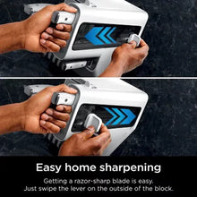 Hand operating a white knife sharpener block with a stainless steel lever