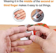 Double-sided cutting board with finger guard being held for safe cutting.