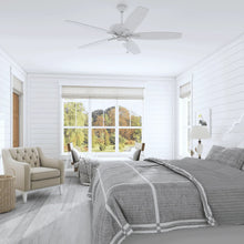 White ceiling fan installed indoors with five reversible blades