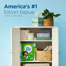Puffs Plus Lotion facial tissue box with green packaging and Puffs logo