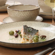 Stoneware dinner bowl with reactive glaze, filled with served dish and garnishes
