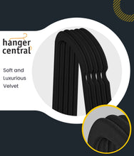 Black velvet clothes hangers with soft ribbed texture and curved shoulders
