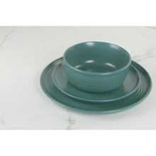 Emerald green stoneware dinner plate with raised center and wide double-line border