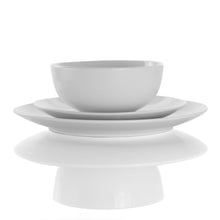 White porcelain bowl with matching plates stacked underneath