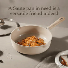 Ceramic nonstick saute pan with lid, wooden handle, holding cooked noodles