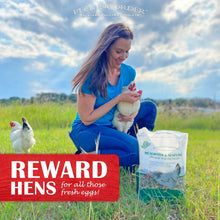 Woman holding mealworm and sunflower treat bag while feeding a chicken outdoors