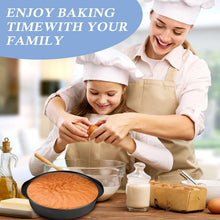 Round black cake pan with sponge batter on a kitchen table during baking