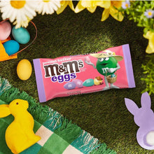 Peanut Butter M&M's Eggs candy bag on grass with Easter candy decorations