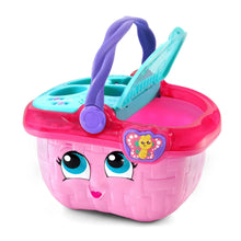 Pink toy picnic basket with purple handle and side view of teal insert