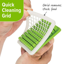Green cutting grid insert held above a white chopper base