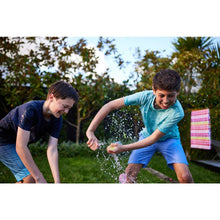 Children throwing water balloons with splashes during outdoor play