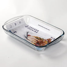 Clear glass baking dish with blue-tinted rim holding cooked food