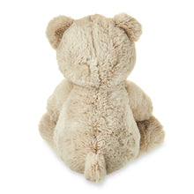 Tan bear plush with fluffy fur, sitting pose with back toward camera