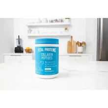 Vital Proteins collagen peptides powder tub on white countertop in a kitchen setting