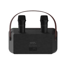 Karaoke speaker unit with two wireless microphones on top and carry strap