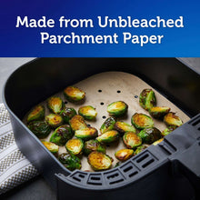 Unbleached parchment air fryer liner holding sliced Brussels sprouts in basket