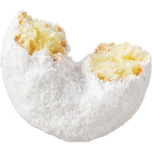 Powdered mini donut with visible yellow filling and white sugar coating