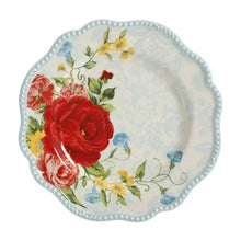 Scalloped dinner plate with red roses, yellow blooms, and blue vine accents