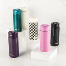 Teal coffee tumbler with flip-top lid displayed with other color tumblers