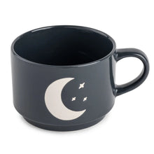Ceramic coffee mug in dark navy with crescent moon and star design, side handle