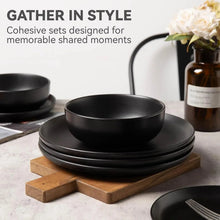 Black matte stoneware dinnerware set with stacked plates and a shallow bowl