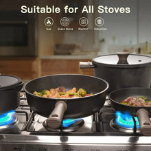 Black nonstick skillet and saucepan on a stovetop, with food in the pans