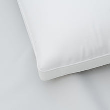 White cooling bed pillow corner with stitched seam on smooth cover
