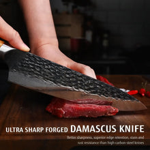 Damascus chef knife with olive-wood handle and textured dark blade