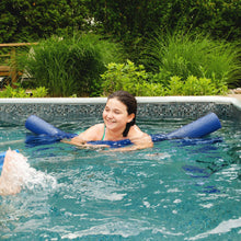 Blue foam pool noodles in use, held by a swimmer in a pool